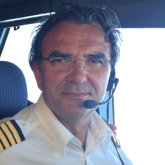 Man with glasses and headsets at cockpit