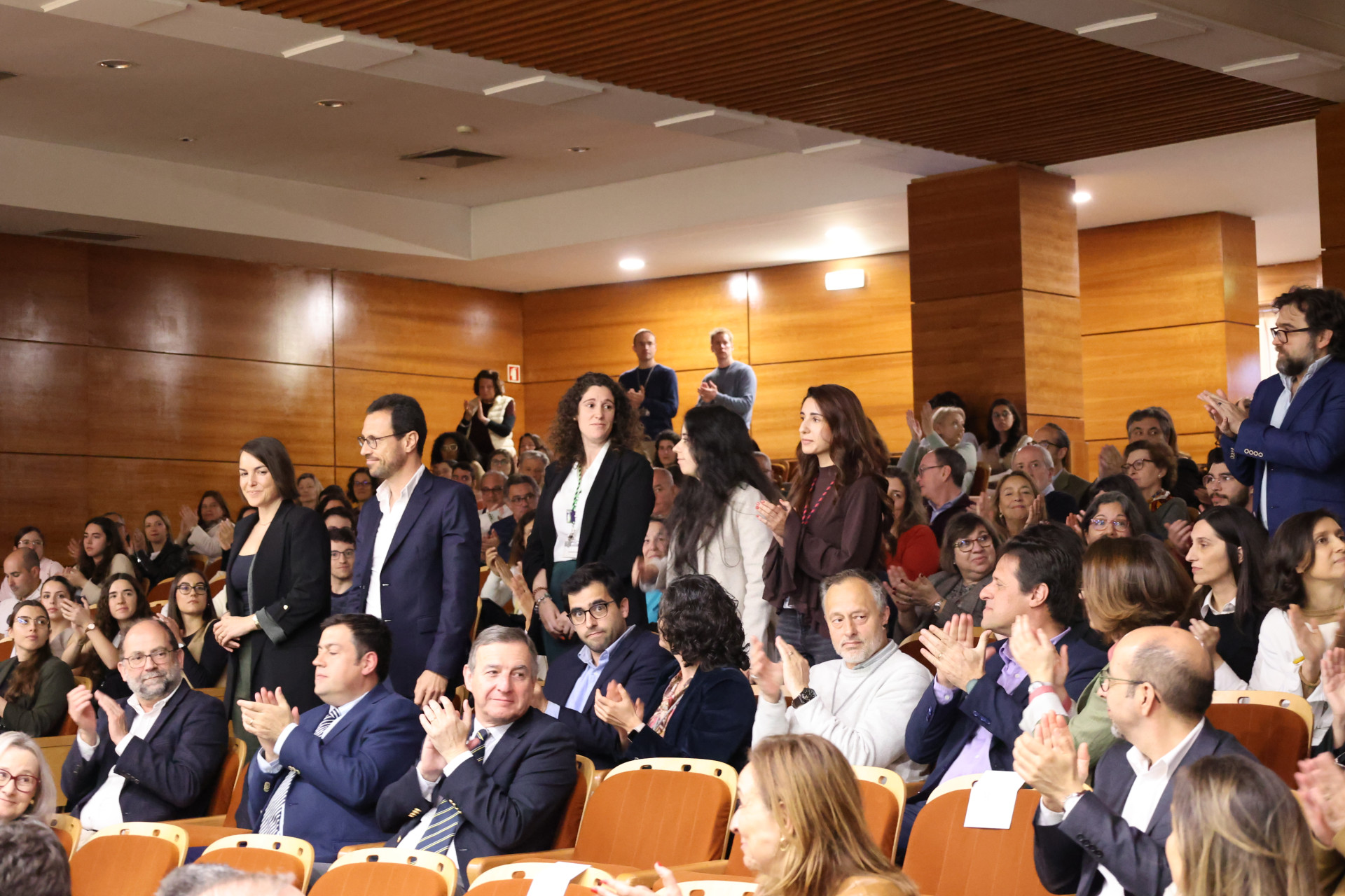 pessoas a aplaudir homenageados